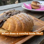 What does a concha taste like? A sweet, fluffy Mexican bread with a signature sugar shell.