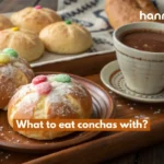 What to eat conchas with: Close-up of conchas paired with hot chocolate.