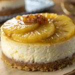 Close-up of Mini Pineapple Upside-Down Cheesecakes with caramelized pineapple topping and creamy cheesecake filling.